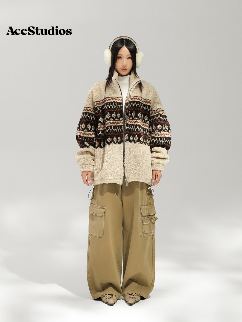 Model wearing a cozy patterned zip-up jacket with wide-leg cargo pants and earmuffs.
