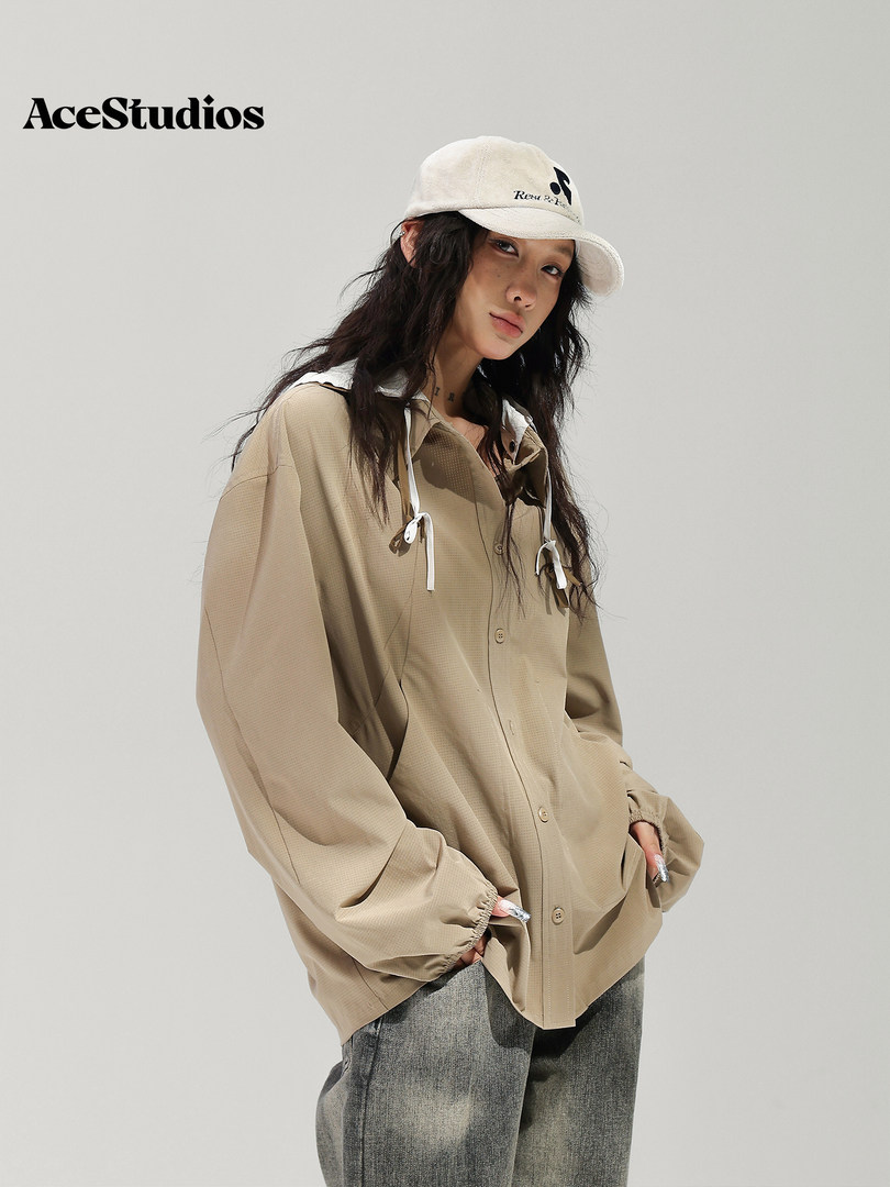 Beige lightweight hooded jacket worn by a model with a matching cap