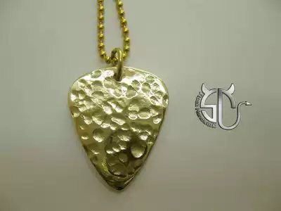 Handmade brass pick necklace on the lunar surface without carving