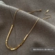 Маленькое колье из титановой стали с золотым слитком