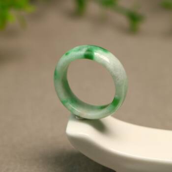 Spicy green natural grade a jadeite ring on white background