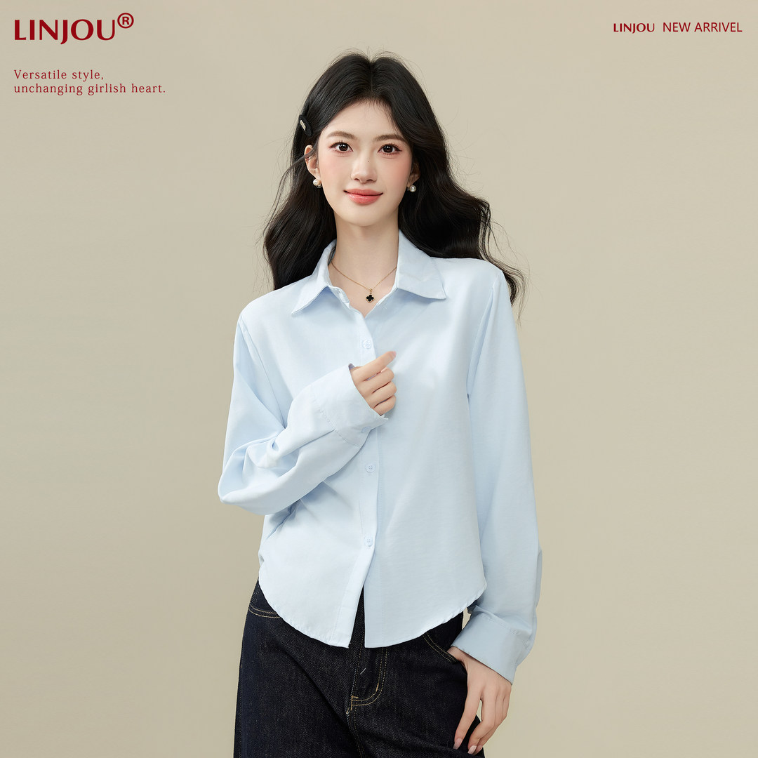 Light blue long-sleeve button-up blouse worn by a model