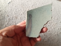 The fragment of a large bowl from the Hebi Jun Porcelain Kiln in the Yuan Dynasty has red spots on it which looks like a pious figure. Specimen