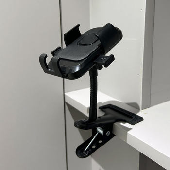 The cameraman has a strong clip to set up a metal mobile phone stand