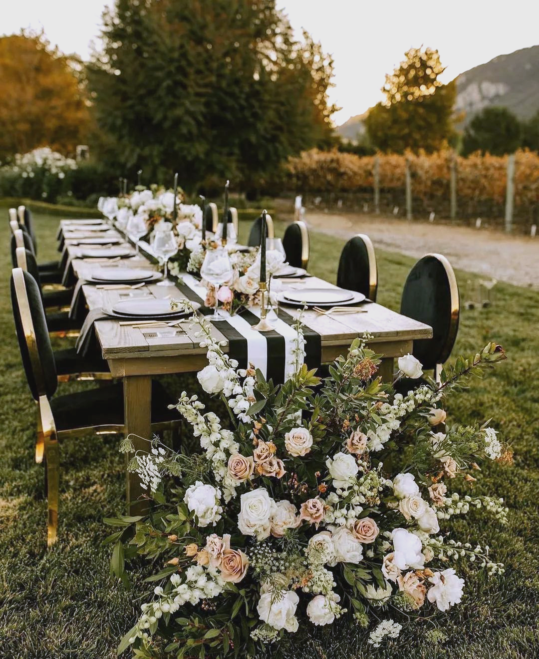 Intimate wedding reception with one or two long tables, warm lighting, and a small group of guests