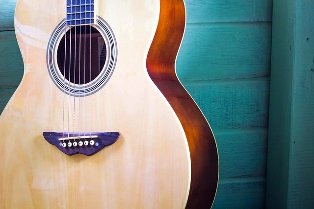 how do you lower the action on an acoustic guitar