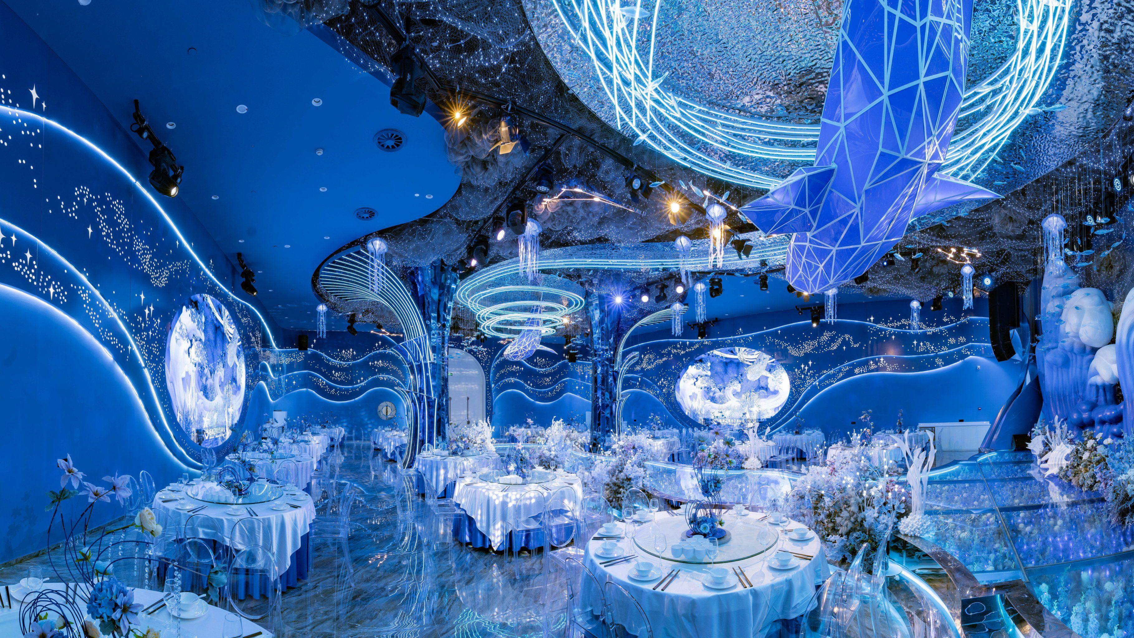 Formal navy blue and white wedding reception with silver accents in a ballroom or modern venue