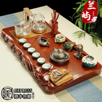 The whole piece of pear solid wood lotus fish edge carved tea tray The whole set of Kung Fu ceramic purple sand tea set automatic household