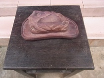 The old wooden seat of the old seat a 80s chic stone (jade) pendulum with a red wooden seat