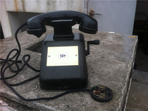 Old-fashioned hand-cranked telephone Bakelite old objects antique nostalgic collection film and television props club bar cabinet decoration