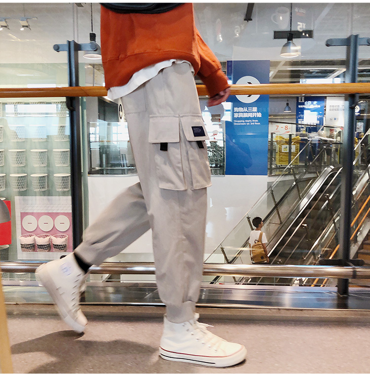 Wozi mùa thu mới màu rắn nhiều túi chùm chân overalls trẻ trung quần lỏng giản dị quần Hong Kong phong cách hoang dã quần baggy nam