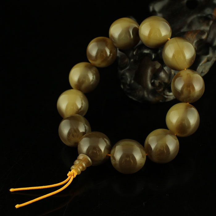 A price of fine natural horns with exquisite round beads hand in hand 