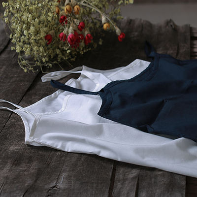 This artistic solid-color cotton base halter dress is a versatile and elegant choice for women in summer. It is a thin white mid-length inner lining dress