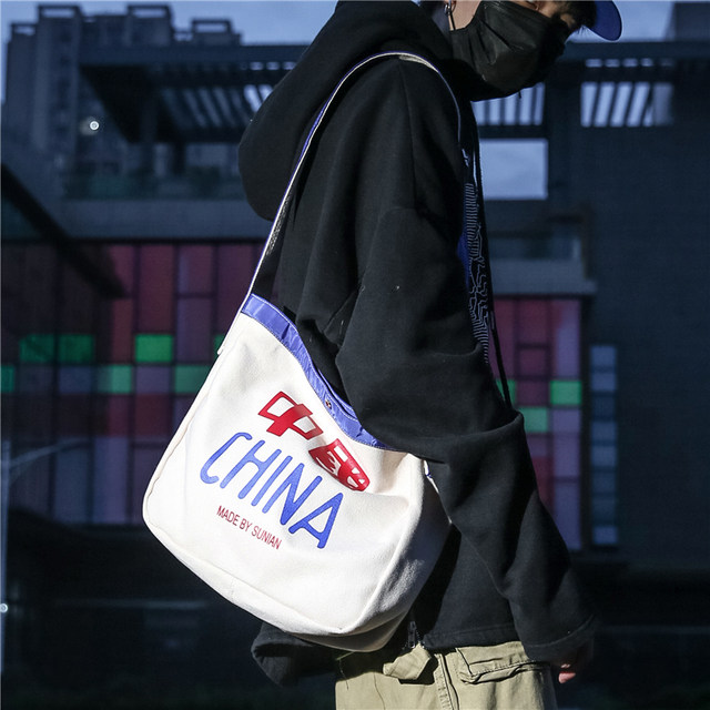 ຍີ່ຫໍ້ Trendy ຕົ້ນສະບັບຈີນ retro canvas bag crossbody bag men's shoulder bag bag style Hong Kong style bag women literary students Korean version