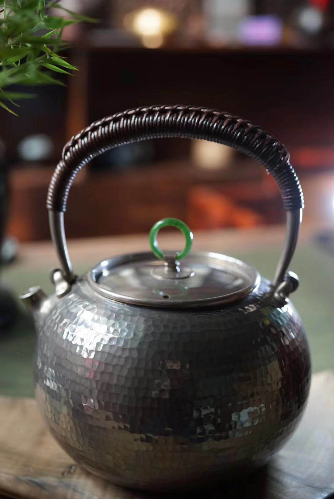 Master hand makes silver pot 