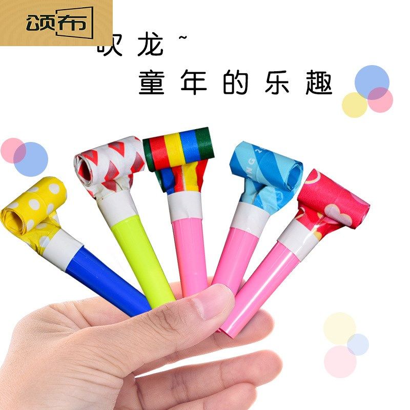 * Children's toy blowing a chuckle with a smiling face blow up a telescopic whistle a small trumpeter can give a birthday party to a small gift