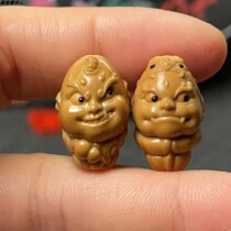 Olive stone carving with gold horn and silver horn. A pair of small seeds and small stones. Journey to the West a cute version of the little goblin. Cute toy.