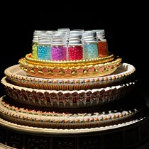 A set of 16 colors of Shakyamunis phantasmagorical solid crystals in a black box containing the stupa