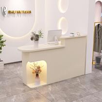 Cream style clothing store cashier arc bar small bar table with light beauty salon reception desk