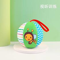 Baby chasing black and white ball toy