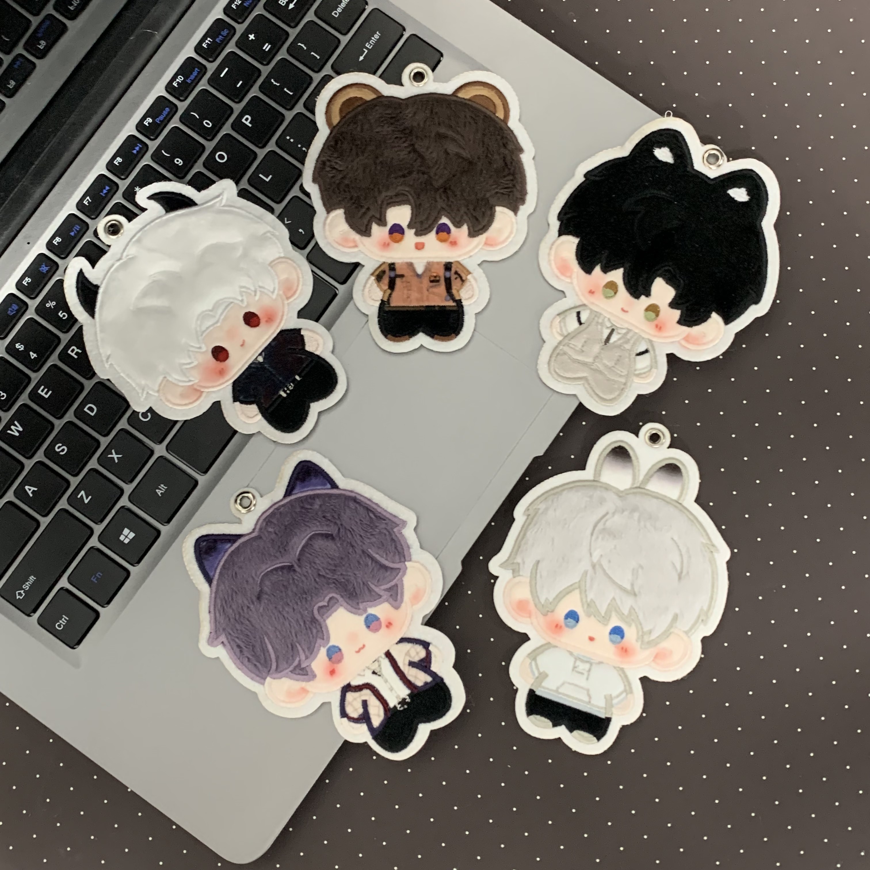 Embroidered character details on the Love and Deepspace plush charm set