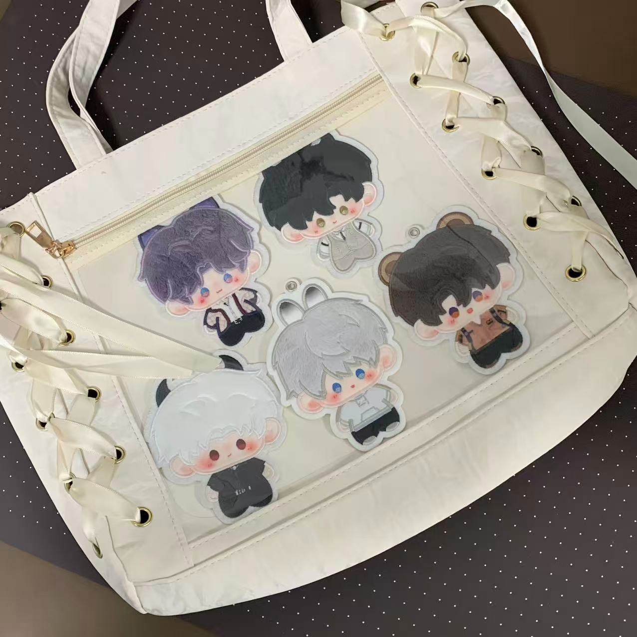 Five Love and Deepspace plush charms displayed in a clear ita-bag pocket