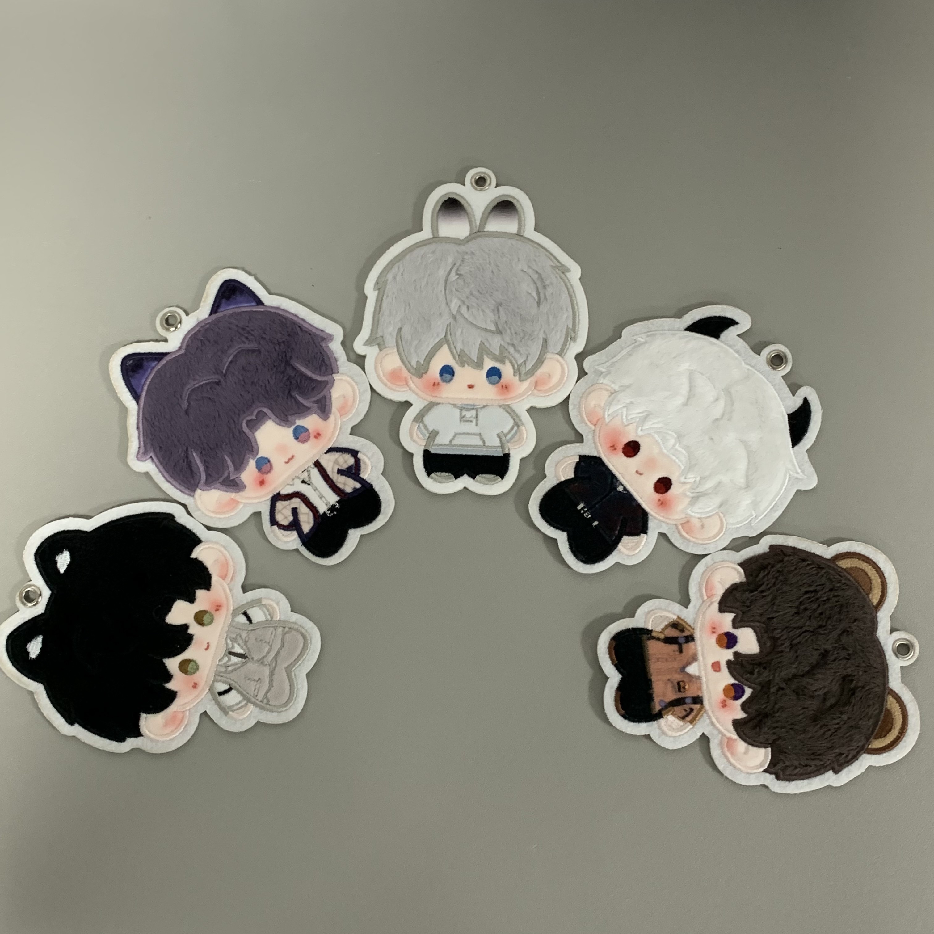 Love and Deepspace plush charm series arranged on a gray background