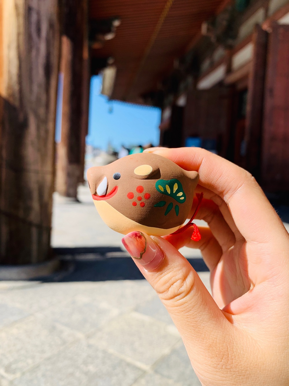 Japan's Kyoto East Monastery The XII Zodiac has a small animal swinging piece containing a Japanese sign for a pig