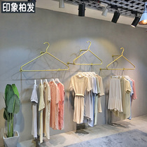 Womens clothing store display rack on the wall gold wall hangers Womens store clothes rack hangers Childrens clothing rack