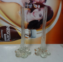 Old vase plugged in 80s pure white glass like foot slender flowers in the old collection of movie props bar