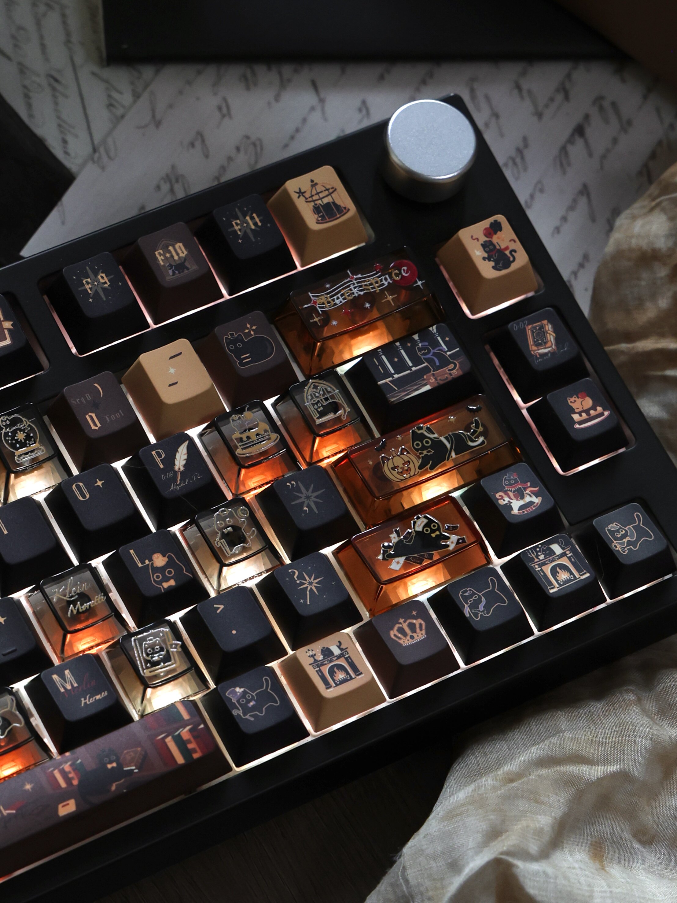 Amber and dark cat-themed PC keycaps on a mechanical keyboard