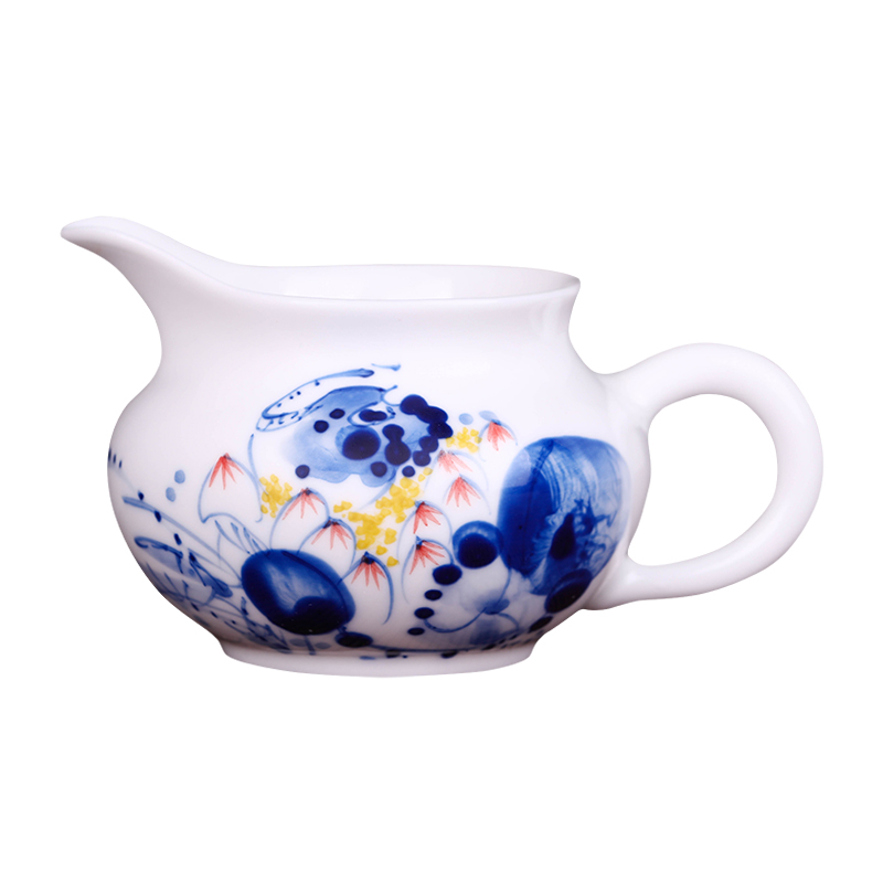 Jingdezhen hand - made ceramic fair cup of tea by hand and points tea exchanger with the ceramics cup against the hot cup of tea sea