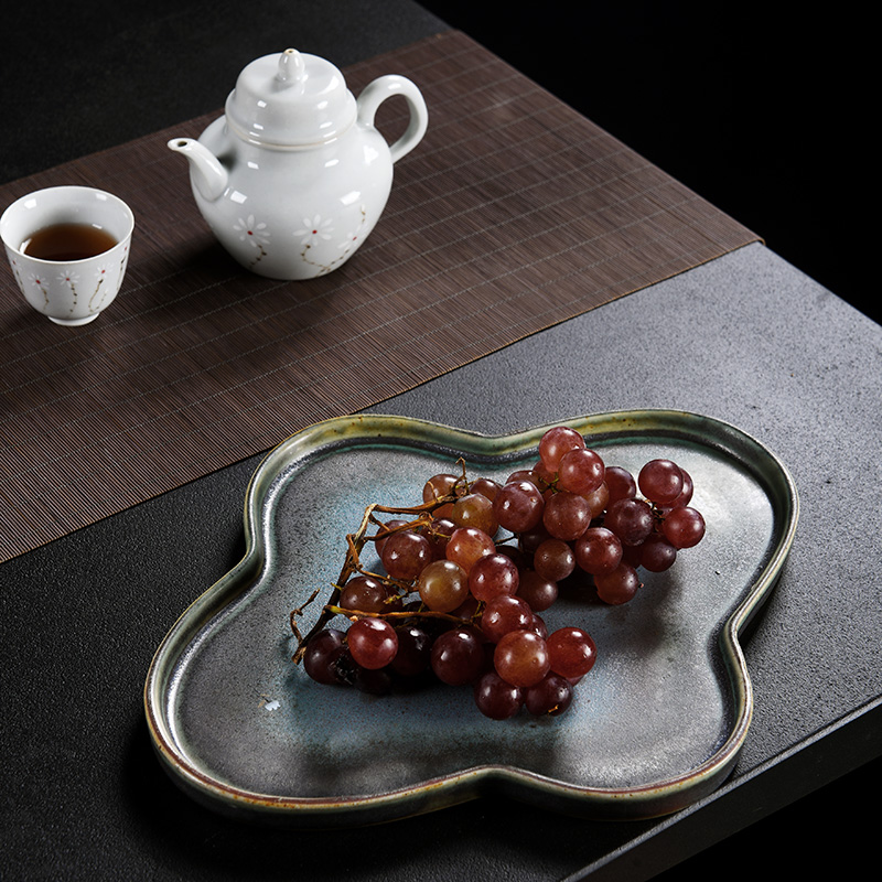 Old ceramic up saucer at the grid plate of Japanese zen tea tray was restoring ancient ways of household dry plate bearing tea pot heart plate