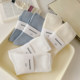ຖົງຕີນສີຂາວຂອງແມ່ຍິງໃນລະດູຮ້ອນ ຖົງຕີນກາງ-calf ບາງໆ ຝ້າຍບໍລິສຸດ ins trendy ສີແຂງກິລາ breathable ພາກຮຽນ spring ແລະ summer socks ຍາວ pile