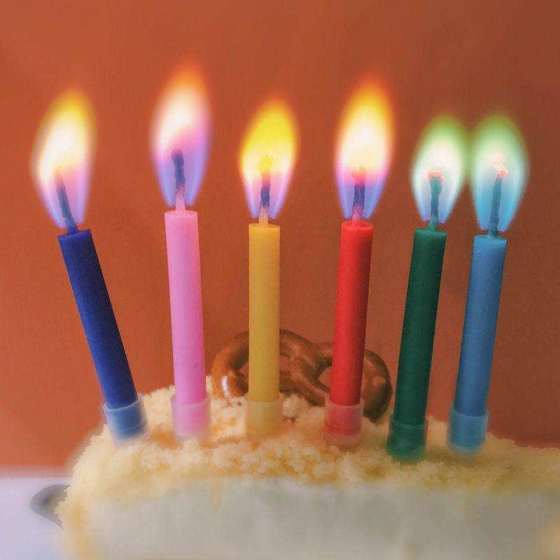 Birthday color flame candle in red creative pink anniversary bake cake decorated smoke-free party