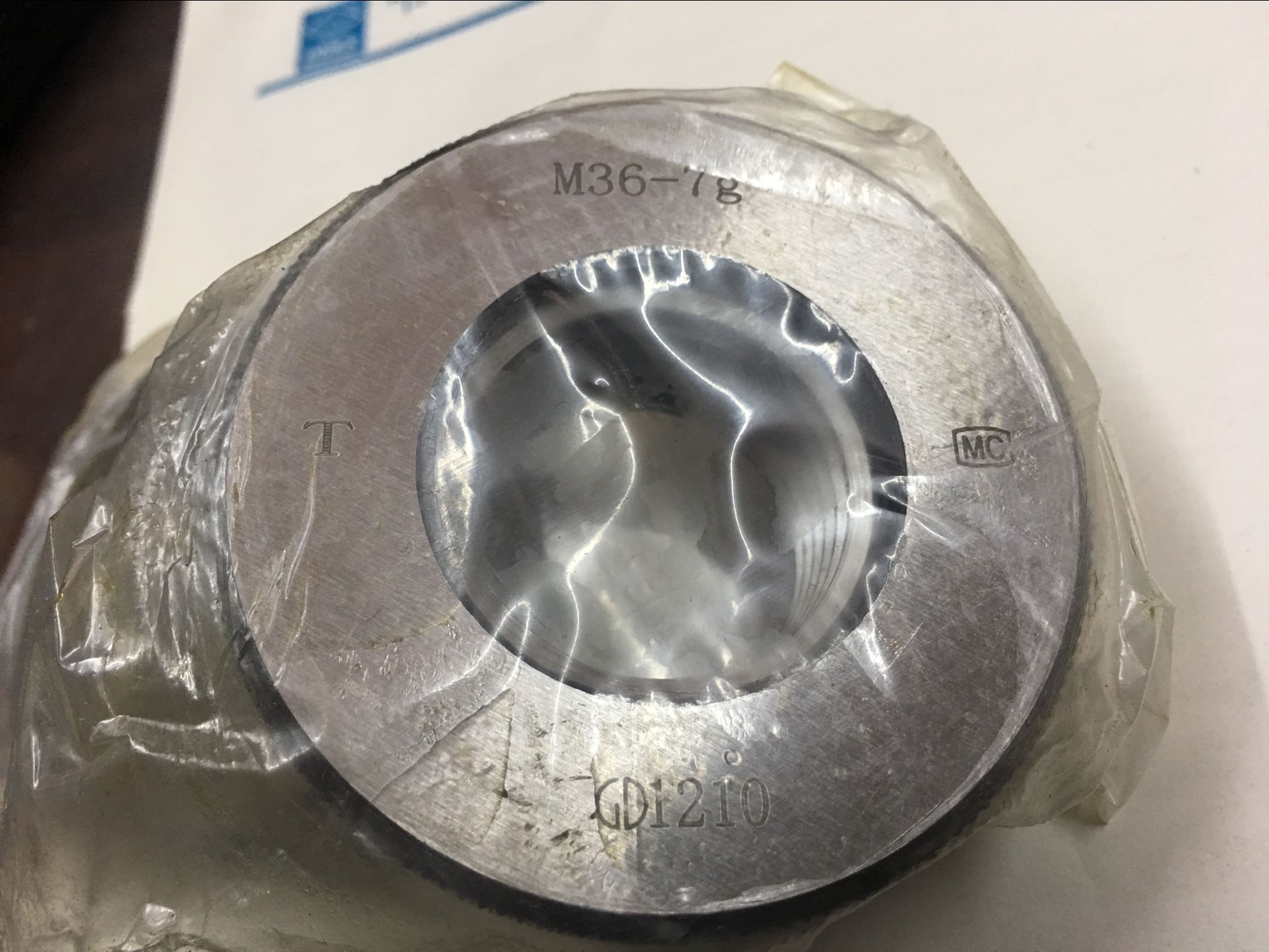 Threaded ring gauge threaded through stop gauge