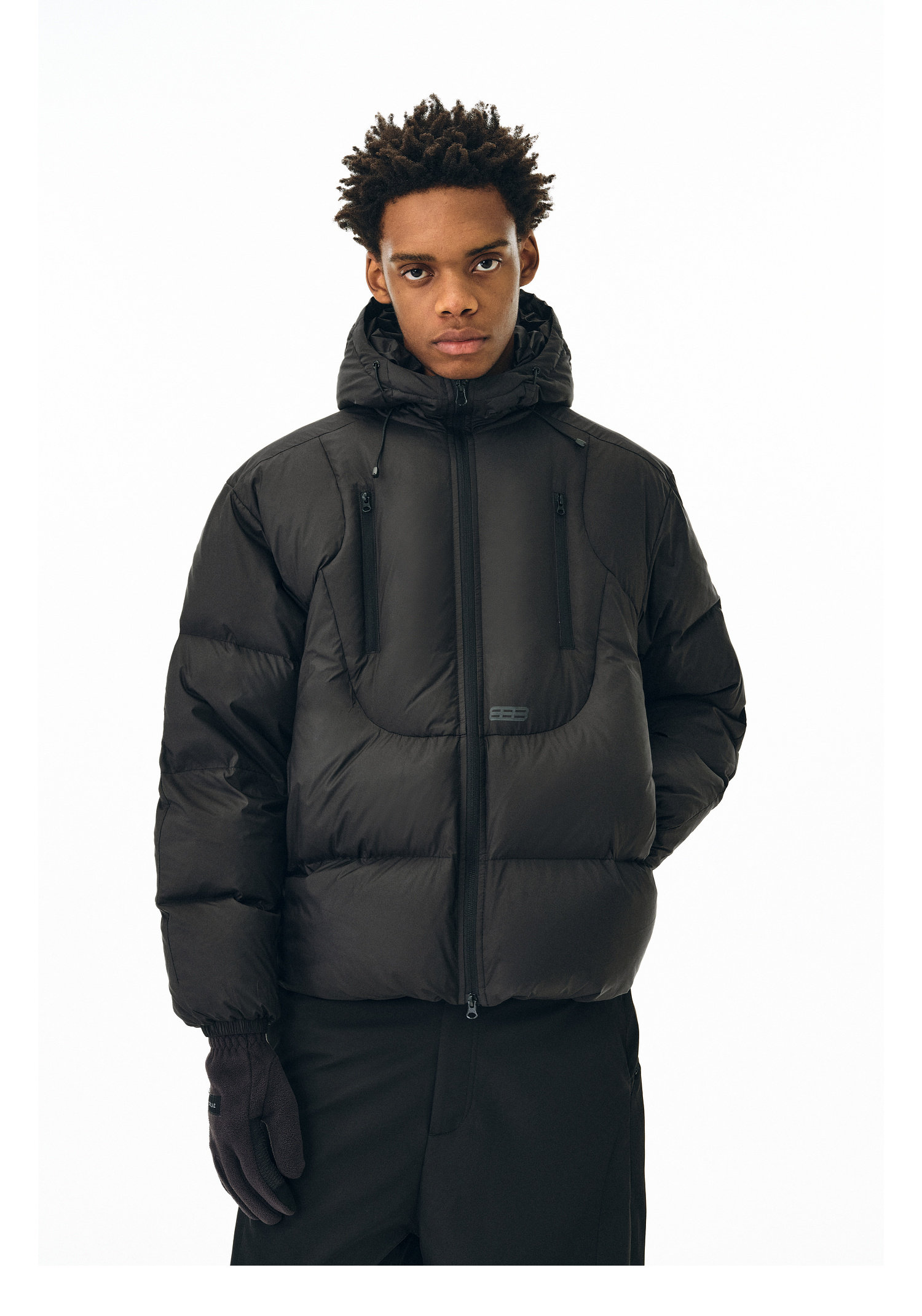 A person models the EastLyst Fashionable 3D short down jacket with a hood and black gloves, standing against a white background and looking directly at the camera with a neutral expression.
