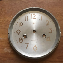 The 5-digit number on the old clock dial is not clear