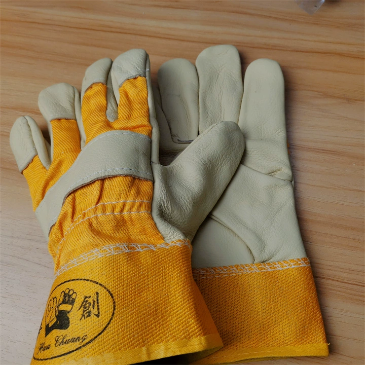 găng tay thợ hàn Vải màu vàng một lớp da bò găng tay hàn ngắn cho thợ hàn polyester cotton đầy đủ lớp da trên cùng Huachuang cách nhiệt chống cháy chịu nhiệt độ cao găng tay da dài bao tay hàn chịu nhiệt