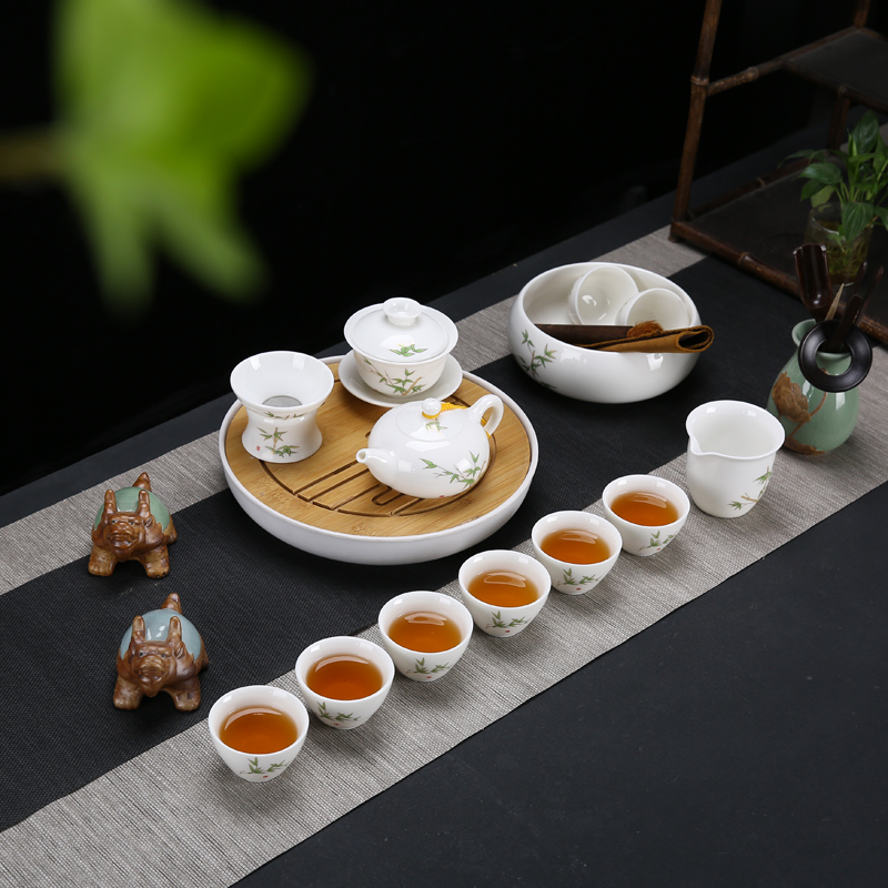 Dehua white porcelain kung fu tea set suit household suet jade cups of a complete set of the tea pot lid to use simple wooden side