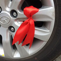 Car turnbus silk with a new car praying for a blessing with car Safe Silk with colored ribbon floating with red strings silk with red strips