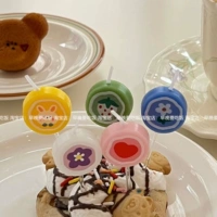 Коробка разноцветных конфетных свечей.