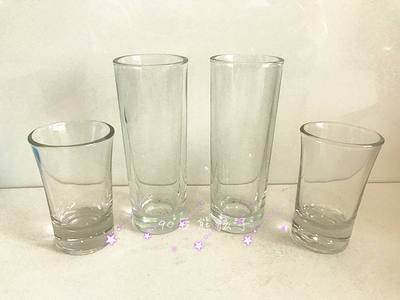 Clearance sale of plain colored tempered glass cups, small wine glasses, vodka cups and soju cups from cartoon and animation export products