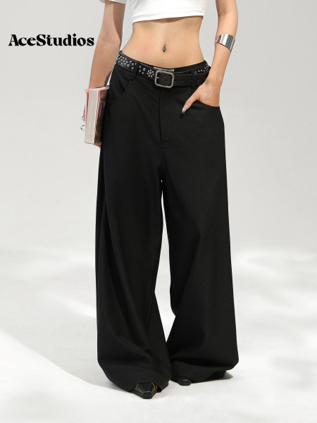 Model wearing black wide-leg pants with a belt and cropped white top