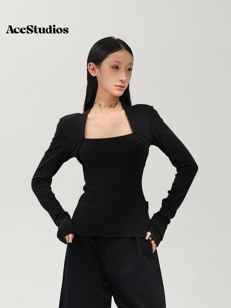Model wearing a black long-sleeve square-neck top with black pants.