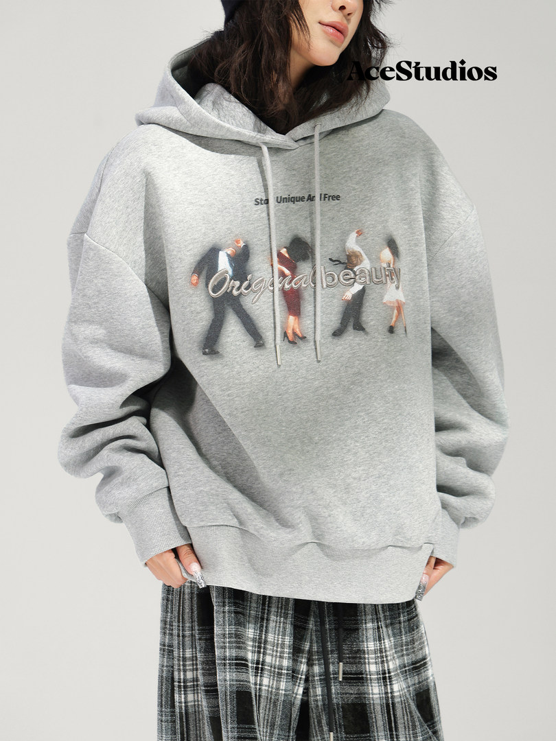 Gray graphic pullover hoodie worn with plaid pants