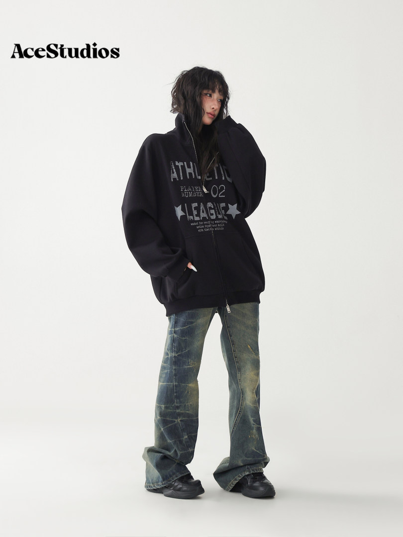 Model wearing an oversized black graphic hoodie with distressed wide-leg jeans and black shoes.