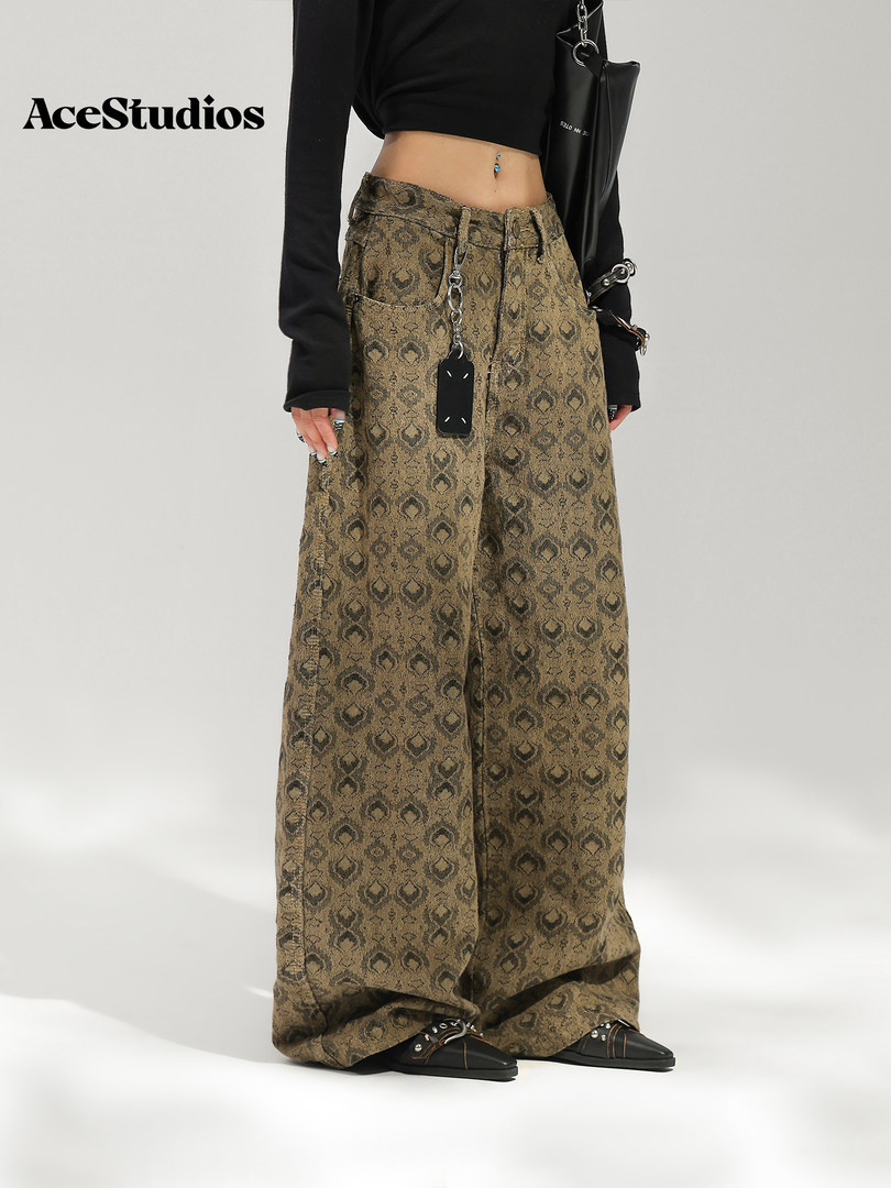 Model wearing wide-leg patterned trousers with a cropped black top and sneakers.