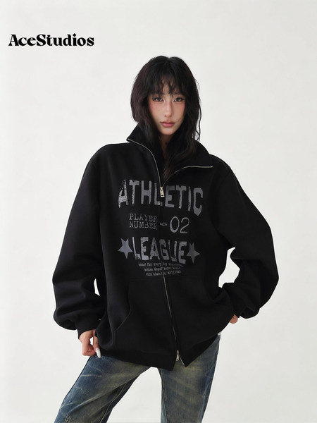 Model wearing a black graphic zip-up hoodie with relaxed jeans.