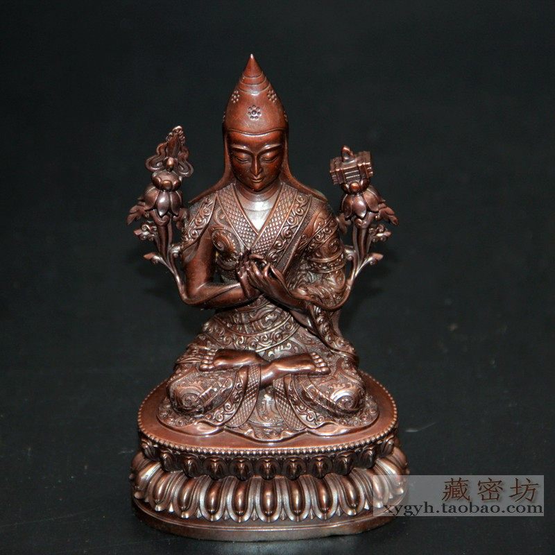 The Tibetan Buddha is a perfect translator of pure copper on the table